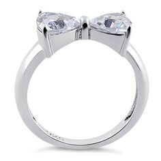 Top of ring height: 7.2mm

Top of ring width: 14.8mm

Band width: 4mm

Shank width: 2.6mm



Stone material: clear cubic zirconia

Stone shape: heart cut

Total number of CZ stones: 2

Stone setting: prong setting



Metal: 925 sterling silver

Plating: rhodium plated

Finish: high polish Sweet Ring, Bow Ring, Stone Material, Silver Bow, Stone Setting, Cz Ring, Lovely Jewellery, Favorite Rings, Sterling Silver Heart