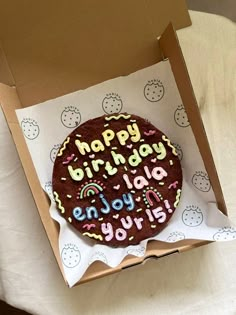 a birthday cake in a box with the words happy birthday on it's side