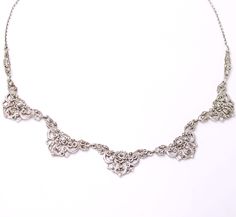 This iconic Art Deco necklace dates aprox from the 1930s. It is solid silver decorated with marcasite gemstones. Marking: ENGLAND SILVER Size: 15 1/2 inches long (39.5 cm). The centre part measures 18 cm long. Weight: 14.5 grams Condition: Very good condition, no missing stones. Stunning dress piece, find more unique ladies chokers in my shop. https://www.etsy.com/uk/shop/perdisjewellerybox?search_query=marcasite+necklace Dress Piece, Dress Necklace, Iconic Art, Choker Dress, Gemstone Choker, Purple Rings, Womens Chokers, Necklace Dress, Art Deco Necklace