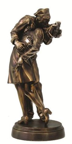 a bronze statue of a woman holding a child