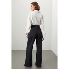 Black denim (100% Cotton). Pants. Side button closure. 32" inseam. 3" rise. Imported. Fall Wide Leg Flare Jeans With Button Closure, Chic Rigid Denim Bottoms For Fall, Relaxed Fit High-waisted Jeans For Fall, Fall High-waisted Relaxed Fit Jeans, Levi's Rigid Denim Jeans For Fall, Levi's Wide Leg Jeans For Workwear, Fall Rigid Denim Flare Jeans For Workwear, High Waist Rigid Denim Pants For Fall, Fall Workwear Flare Jeans In Rigid Denim