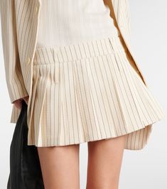 Blake pleated pinstripe twill miniskirt in neutrals - The Frankie Shop | Mytheresa Striped Pleated Fitted Skirt, Elegant Workwear Skort With Accordion Pleats, Spring Office Wear Pleated Skort, Chic Striped Pleated Bottoms, Pleated Skort For Office In Spring, Classic Mini Pleated Skirt For Work, Spring Mini Skirt With Vertical Stripes, Chic Striped Fitted Skort, Chic Fitted Striped Skort