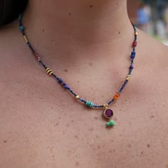 a woman wearing a multicolored beaded necklace