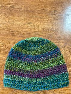 This listing is for a beautiful crocheted hat. The yarn is nice and soft. The hat is made from acrylic yarn and has beautiful green tones in it. There is also some wine and teal colors hinted. It is a wonderful combination of colors. The hat is appropriate for men or women and would look fabulous on both!  The hat measures 8 inches from crown to brim and with fit a 22-23 inch head.  Made in a smoke free home! To care for the hat, machine wash cold. Do not bleach. This hat can also be dry cleaned Murphy Nc, Crochet Bonnet, Crocheted Hat, Skull Cap Beanie, Green Tones, Teal Colors, Skull Cap, Acrylic Yarn, Other Colors