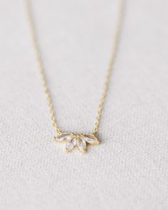 This stunning Gold Crystal Flower Necklace is crafted from gold vermeil with a beautiful crystal flower. measures 17.75" at longest, 15.75" at shortest Elegant Gold Flower Jewelry, Elegant Gold Floral Jewelry, Elegant Flower-shaped Gold Jewelry, Elegant 14k Gold Jewelry With Flower Charm, Elegant Gold Crystal Necklace, Gold Plated Flower Pendant Jewelry For Wedding, Elegant Rose Gold Crystal Necklace With Delicate Chain, Delicate Gold Plated Jewelry With Flower Charm, Gold Flower-shaped Cubic Zirconia Necklaces