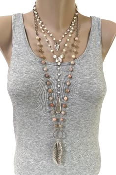 This layered look consists of three separate necklaces that can be purchased individually or as a set.  Shortest necklace adjusts from 15 to 17 inches and consists of hand wrapped Freshwater Pearls and a dainty matte silver heart pendant. Closes with a lobster clasp.  The middle rosary-style necklace is made using the same Freshwater Pearls and accented with a matte silver connector and teardrop pendant. The necklace measures 20 inches to the connector and closes with a lobster clasp. PLEASE NOT Boho Necklace Diy, Boho Jewellery Necklaces, Rosary Style Necklace, Layered Beaded Necklaces, Autumn Jewelry, Medieval Wedding, Necklace Outfit, Long Beaded Necklace, Bohemian Necklace