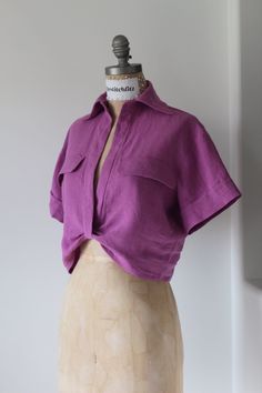 a mannequin with a purple shirt on it's head and neckline