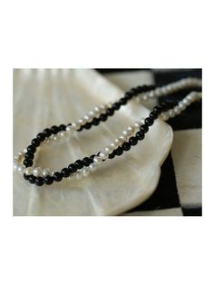 Experience the timeless contrast between black onyx and white pearls with this simple yet striking design. Natural pearls add a soft beauty, while black agate adds a unique charm. This necklace can be DIY by yourself. The two beads are scattered and have a sense of hierarchy. They are twisted together and have a sense of design Metal: 18ct Recycled Gold Plated On Brass Gemstone: Black Onyx Pearl: Freshwater Pearl (4-4.5mm) Length: 360-410mm Weight: 18g Necklaces Pearl, Natural Pearl Necklace, Soft Beauty, Double Layer Necklace, Edison Pearls, Gemstone Beaded Necklace, Layer Necklace, Pearl Necklaces, Tiger Eye Stone