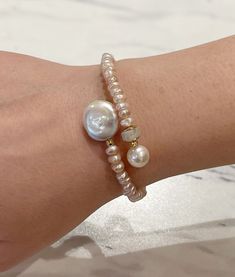 This Moonstone, Pearl & Coin Pearl Memory Wire Bracelet is the perfect way to complete your outfit! This piece of jewelry is made with all-natural stones, and the coil pearl adds some sparkle to your wrist. It's easy to take on-and-off with its memory wire - no clasp necessary! Get ready to shine. Luxury Pearl Bracelets With Pearl Embellishments, Luxury Wedding Oyster Pearl Bracelet, Luxury Beaded Bracelets With Pearl Drop, Luxury Pearl Beaded Bracelets With Round Beads, Luxury Beaded Bracelets With Pearl Charm For Formal Occasions, Pearl Layering Bracelets, Luxury Pearl Bracelet With Round Beads, Affordable Pearl Bracelets For Parties, Cheap Bohemian Pearl Bracelet For Gift