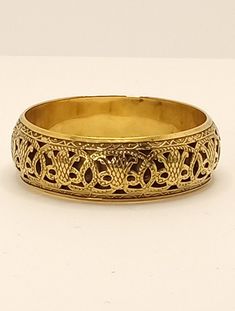 Vintage Chunky Brass Openwork Embossed Bangle Bracelet Estate Find A light weight, hollow open work brass bangle with a lot of charm. The embossed design gives this piece depth and allows the light to play on the highs and lows. Inner circumference: 8.2 inches Width: .9 inch Thickness: .2 inch This is a pre-owned vintage item, it has been cleaned, inspected and found to be in very good vintage condition with minimal signs of wear. Comes in a gift box ideal for gift giving and storage. Item# BR00 Formal Brass Bangle With Intricate Design, Brass Bracelets With Intricate Design For Festivals, Yellow Gold Brass Bangle With Intricate Design, Symbolic Gold Bracelets For Festivals, Gold Ornate Brass Cuff Bracelet, Ornate Bronze Bracelets With Intricate Design, Bronze Brass Bracelets With Intricate Design, Gold Bohemian Etched Cuff Bracelet, Gold Cuff Bracelet With Antique Finish