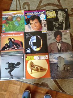 a person standing on the floor in front of many different cd's and cds