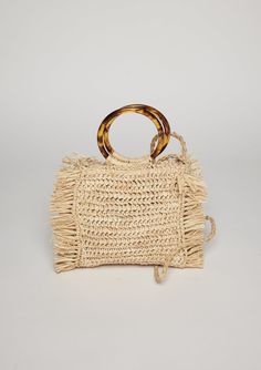 Fringed straw bag with a round tortoise handle and optional crossbody strap, our Tort bag is one of our spring and summertime favorites! Material: 100% Raffia; Lining- 100% Linen; Handles- 100% Plastic 17cm x 16cm: Strap Length 120cm Spot Clean with Damp Cloth Chic Woven Beach Bag With Round Handle, Beige Straw Shoulder Bag With Round Handle, Beige Crochet Straw Bag With Round Handle, Summer Beach Bag With Detachable Handle In Natural Color, Chic Jute Straw Bag With Round Handle, Straw Bag With Round Handle For Beach, Natural Top Handle Straw Bag For Day Out, Chic Spring Beach Bag With Round Handle, Trendy Woven Straw Bag With Round Handle