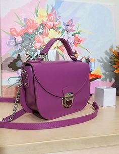 A small handbag made in an incredibly beautiful and attractive violet color. Beautiful, charming and very comfortable. Despite its small size, it easily fits everything you need. Our handbag is made of smooth genuine leather, with a leather lining inside. All edges are processed and painted by hand, making the handbag look neat and expensive. There are two pockets in total inside the bag. The bag closes with a zipper and lock. Size: 8 x 6 x 3 inches (20 x 16 x 8 cm). Purple Crossbody Bag As Gift, Trendy Handmade Purple Bag, Purple Crossbody Bag For Gift, Handmade Trendy Purple Bag, Purple Clutch Bag For Everyday Use, Purple Top Handle Bag As Gift, Purple Top Handle Shoulder Bag As Gift, Pink Leather Box Bag For Gift, Trendy Handmade Crossbody Satchel