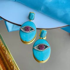 This stud earring has a turquoise stone stud and an oval shaped turquoise stone on which a beautiful eye shaped white and red zircons are studded all in brass metal with 18K gold plating. It's a perfect go to earring which suits with any outfit whether it is traditional or indo-western or western outfit. This is all handmade earring Oval Stone Earrings Gift, Oval Stone Earrings For Gift, Turquoise Oval Earrings With Natural Stones, Turquoise Multi-stone Round Jewelry, Oval Turquoise Multi-stone Jewelry, Luxury Hand-tooled Turquoise Jewelry, Luxury Turquoise Gemstone Earrings, Turquoise Earring, Southwestern Multi-stone Turquoise Jewelry