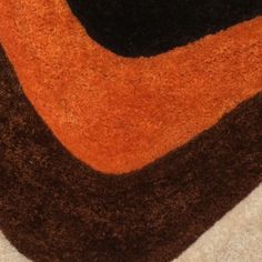 an orange and black rug on the floor