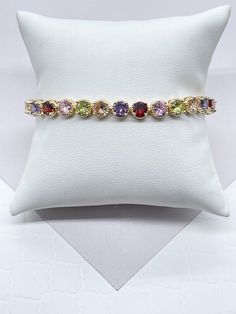 "18k Gold Filled Round Multi-Color Zirconia Bracelet. Buy with confidence we add insurance to every shipping package. Our Etsy store was developed to help you find the most unique styles of modern designs, always looking for elegance and market trends. Here you will find ways to better make your jewelry through quality, seeking harmony, exclusivity and impeccable finish. Find many more styles in our Milie Jewelry Etsy Store. https://www.etsy.com/shop/miliejewelry You can choose from unique style Multicolor Bracelets With Sparkling Stones For Gift, Multicolor Gemstone Tennis Bracelet As A Gift, Multicolor Gemstone Tennis Bracelet As Gift, Multicolor Cubic Zirconia Tennis Bracelet Gift, Multicolor Cubic Zirconia Tennis Bracelet With Multi-stone, Multicolor Multi-stone Cubic Zirconia Tennis Bracelet, Multicolor Gold Bracelet Gift, Multicolor Bracelets With Sparkling Stones, Multicolor Cubic Zirconia Crystal Bracelet