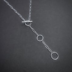 Elevate your everyday look with this handcrafted Paperclip Chain Toggle Necklace. The unique toggle clasp adds a touch of modern charm, while the adjustable length allows for versatile styling options. Made from high-quality sterling silver, this necklace is the perfect addition to your jewelry collection. Details: Chain: Solid Sterling Silver Paperclip Chain, 3mm Clasp: Handcrafted Sterling Silver toggle clasp, adjustable length Sizes: 16 inches to 24 inches Shipping: Ready to ship within one b Minimalist Paperclip Toggle Necklace With Lobster Clasp, Minimalist Paperclip Toggle Necklace With Adjustable Chain, Modern Toggle Necklace With Toggle Clasp For Everyday, Modern Everyday Toggle Necklace With Clasp, Modern Toggle Clasp Necklace For Everyday, Minimalist Toggle Necklace With Paperclip Chain, Minimalist Chain Necklace With Toggle Clasp, Modern Toggle Necklace With Lobster Clasp, Silver Minimalist Lariat Necklace With Lobster Clasp