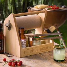 a grill master's tool holder with bottles and saucers on a wooden table