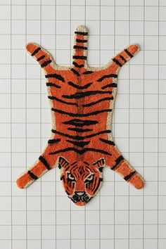 an orange rug with a tiger on it's back in the shape of a man