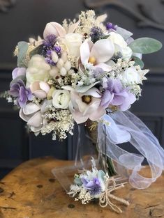 a bouquet of flowers sitting on top of a wooden table