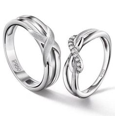 two silver rings with diamond accents on each one and the word love is written in white gold