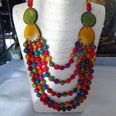 This Is Organic Vegan Jewelry Made By A Master Artisan Jewelry Maker From Ecuador. Multistrand, Multicolor With Matching Pink Earrings. The Sliding Cord Allows To Wear The Necklace At A Length That Goes Best With The Outfit. Multi Color Allows This Jewelry To Match Many Outfits. Tagua Nut Is A Product Of Tagua Palm Trees That Grow In Ecuador's Amazon Rainforest. Your Purchase Allows Treasure Of Andes To Place New Orders With Artisans' Families. Thanks For Looking, All Questions Ate Welcome. Artisan Multicolor Jewelry With Wooden Beads, Colorful Jewelry With Wooden Beads For Beach, Multicolor Dangle Jewelry For The Beach, Multicolor Wooden Beads Jewelry, Multicolor Dangle Jewelry For Beach, Colorful Wooden Beads Jewelry For Beach, Multicolor Wooden Round Beads Jewelry, Artisan Multicolor Wooden Beads Jewelry, Unique Multicolor Wooden Bead Jewelry