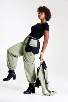 "Let them catch your vibe wearing this edgy pant set with matching jacket. This combo is crafted with cotton, mixed with denim, and designed with three pockets on the jacket, and three pockets on the pants, Cargo style! The jackets design is color blocked for that edginess it brings and the pants has a unique outer pocket on the left front and a half belt closure. Pair up this outfit with a cute bandeau top, or bodysuit and combat boots, Make all your friends wish they had this set too. All of o Winter Military Style Cotton Cargo Pants, Casual Winter Bottoms With Functional Pockets, Green Utility Cargo Pants For Winter, Casual Bottoms With Functional Pockets For Winter, Fall Military Cotton Pants, Trendy Green Parachute Pants With Multiple Pockets, Fall Cotton Parachute Pants With Patch Pockets, Cotton Parachute Pants With Patch Pockets For Fall, Trendy Cotton Parachute Pants With Multiple Pockets