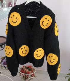 The cardigan is knitted with soft and thick yarns and is completely handmade. The cardigan is 50... 55 cm long and can be knitted to the desired length. The emoji motifs on it are fixed with 3D processing technique. The cardigan, which can be machine washed in a short program, does not fade. So why the affordable price? As HeyÇKnitting, I trust my designer cardigans and want all women in the world to wear these designs with pleasure COLOR: black. (Desired color can be knitted upon order.) MODEL: Black Oversized Acrylic Outerwear, Oversized Black Acrylic Cardigan, Black Acrylic Casual Sweater Coat, Black Acrylic Cardigan, Black Acrylic Cardigan For Winter, Winter Black Acrylic Cardigan, Cozy Knitted Black Sweater, Black Knitted Acrylic Cardigan, Cozy Black Knitted Sweater