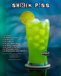 a green drink with a slice of lemon on the rim in front of a blue background