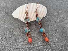 These lightweight art deco dangle earrings feature blue jasper gemstones and up-cycled coral-colored glass beads wrapped in high-quality pure copper. Flaunt this elegant organic look with a breezy deco feel to compliment your style and elevate any outfit. This piece is part of the Sunset Festival collection. Inspired by the vibrant and eclectic festivals in tropical settings, this collection bursts with color and playful designs that capture the lively and colorful essence of lush festivals and sunsets. Shop the collection here: https://www.etsy.com/shop/TheSubtleParts?ref=dashboard-header&section_id=50100681 Give as a memorable unique gift to the favorite woman in your life:  For Mother's Day, anniversary presents, Christmas gifts, birthday gifts, graduation and bachelorette parties. ## S Bohemian Wrap Earrings With Ear Wire, Bohemian Ear Wire Jewelry For The Beach, Bohemian Nickel Free Earrings For Vacation, Bohemian Hand Wrapped Wire Earrings, Adjustable Bohemian Wrap Earrings, Bohemian Earrings With Ear Wire For Vacation, Bohemian Wire Wrapped Earrings, Artsy Summer Earrings With Ear Wire, Bohemian Handmade Wire Earrings