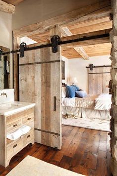 an open door leading to a bedroom with a bed in the background and wooden floors