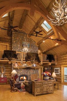 a living room filled with furniture and a fire place in the middle of a wooden floor