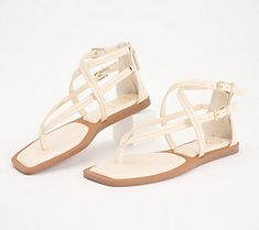 These strappy sandals are sure to show off your fashionista side. From Vince Camuto. Toe Post Strap Sandals For Spring, Spring Toe Post Sandals With Strap, Spring Open Toe T-strap Sandals With Strap, Spring Flat Strap Sandals, Spring Flat Sandals With Strap, Spring Flat T-strap Sandals With Buckle Closure, Spring Buckle Closure Flat T-strap Sandals, Strappy T-strap Sandals For Spring, T-strap Sandals For Spring