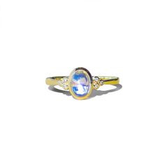 Artemis 14K Gold Moonstone Gemstone Diamond Ring  Details: 14K Solid Gold 1 Piece 5 x 7 mm Oval-Cut Moonstone  ｜Blue｜ Eye-Clean Clarity Moonstone CTW: 0.90 Diamond Color-Clarity: G Color ｜ VS Clarity Diamond CTW: 0.08 Moonstone is considered a feminine stone, a lucky charm linked to the tides, the ocean, the earth, inner mothers and children, and the cyclical nature of women. Wearing a moonstone is said to evoke the power of the divine lunar Goddess within you, connecting your soul with the insurmountable pure energy of the moon.  5 3/4 US size is in stock. Other sizes will take 1-2 weeks to make and ship. ▶ See more of our Moonstone Rings Here: https://www.etsy.com/listing/1606859010 https://www.etsy.com/listing/1606843306 ▶ See more of our Moonstone Earrings to match this ring Here: http Celestial Oval Cabochon Gemstone Rings, Celestial Style Oval Cabochon Gemstone Ring, Celestial 14k Gold Opal Gemstone Ring, Heirloom Style Yellow Gold Moonstone Ring, Celestial Opal Birthstone Ring In Oval Shape, Celestial Oval Opal Birthstone Ring, Celestial Moonstone Ring In Yellow Gold, Gold Moonstone Ring With Accent Stones Fine Jewelry, 14k Gold Oval Moonstone Ring