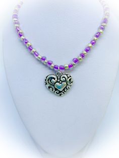 This is a gorgeous Purple and Silver colour Glass Heart Handmade Necklace with Ornate Antique Silver colour heart pendant which features beautiful purple and silver coloured seed beads, The centrepiece is an ornate antique silver colour heart pendant. It is approx 18 inches in length and finished with a silver colour spring ring clasp. To view more JulieDeeleyJewellery items from my shop please click link below : http://www.etsy.com/shop/JulieDeeleyJewellery JULIE DEELEY JEWELLERY SOCIAL MEDIA LINKS Follow me on Facebook: www.facebook.com/juliedeeleyjewellery Follow me on Twitter: twitter.com/julie_deeley Follow me on Pinterest: pinterest.com/juliedeeley Follow me on Instagram: http://instagram.com/juliedeeley Valentine's Day Gift Beaded Necklace, Jewellery Social Media, Purple Bead Necklace, Purple And Silver, Purple Necklace, Purple Pearl, Handmade Heart, Silver Colour, Seed Bead Necklace