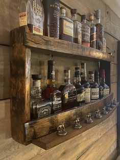 a wooden shelf filled with lots of bottles