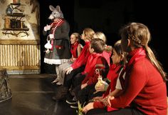 a group of people sitting on top of a stage