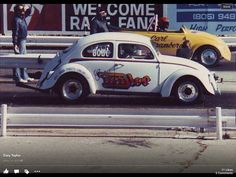 an old time car is painted white and has graffiti on it