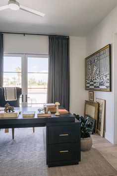 a living room filled with furniture and a large window