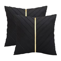 two black pillows with gold stripes on them