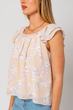 Introducing the Freda Double Sleeve Floral Top, a delightful fusion of elegance and charm designed to elevate your wardrobe. Crafted with care and attention to detail, this top is a testament to timeless sophistication and contemporary style.The Freda top features short double sleeves that add a unique twist to the classic silhouette, offering a playful yet refined look. The neckline shirring adds texture and visual interest, while the vibrant floral pattern lends a touch of romance and feminini Feminine Top, Tailored Pants, Classic Silhouette, Floral Top, Favorite Jeans, Double Layer, Cap Sleeves, Contemporary Style, Floral Tops