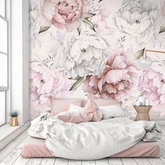 a bedroom with pink and white flowers on the wall