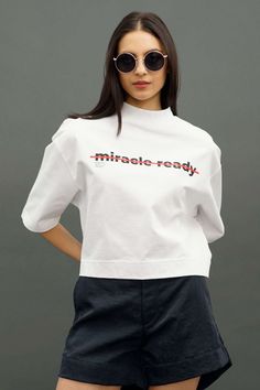 White Heavy Weight Mock Tee Cotton Graphic Tee Cropped T-shirt With Crew Neck, Cotton Graphic Cropped T-shirt With Crew Neck, Graphic Cotton Cropped T-shirt With Crew Neck, Cotton Athleisure T-shirt With Branding, Graphic Print Crew Neck Cropped T-shirt, Cotton Crew Neck Cropped T-shirt With Graphic Print, Modern Short Sleeve T-shirt With Letter Print, Modern Relaxed Fit T-shirt With Text Print, Athleisure Tops With Graphic Print And Short Sleeves