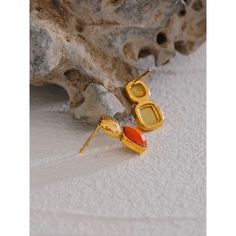 Aretha Orange Stud Earrings Vibrant Personality: The orange hue reflects boldness, energy, and an unapologetic sense of self. These earrings are a tribute to individuality and confidence, offering a striking accessory that commands attention and radiates positivity. Striking Gemstone: The carefully chosen orange gemstone adds a radiant pop of color to your ensemble. The Aretha Orange Stud Earrings feature a captivating design that embodies the spirit of energy and creativity. The vibrant orange Sense Of Self, 18k Gold Earrings, Gold Statement Earrings, Burst Of Color, Stunning Earrings, Vibrant Orange, Gold Earrings Studs, Everyday Look, Statement Earrings