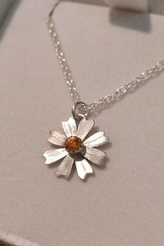 Simple and sweet, this dainty daisy flower necklace glows bright with golden citrine where each petal is hand-sculpted from sterling silver, textured, and soldered together to form this precious hand-crafted necklace. Handmade Sterling Silver Petal Jewelry, Dainty Daisy Sterling Silver Jewelry, Yellow Sterling Silver Flower Jewelry, Silver Daisy Jewelry Gift, Silver Daisy Jewelry For Gift, Dainty Daisy Silver Jewelry, Delicate Sterling Silver Petal Jewelry, Sterling Silver Daisy Flower Charm Jewelry, Sterling Silver Daisy Jewelry With Flower Charm