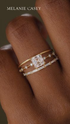 a woman's hand with a ring on it and a diamond in the middle