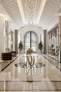 an elegant foyer with chandelier and marble flooring is seen in this image