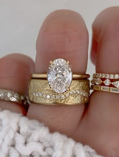 two gold wedding rings with diamonds on them, one in the middle and one in the middle