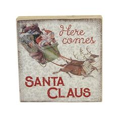 there is a sign that says here comes santa claus