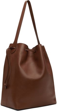 Polished saddle calfskin tote in brown. · Fixed shoulder strap · Silver-tone logo stamp at side · Drawstring closure · Zip and patch pocket at interior · Grained leather lining · H14.5 x W17 x D7 Supplier color: Coffee Brown Calf Leather Satchel With Double Handle, Classic Brown Calf Leather Bucket Bag, Brown Calf Leather Crossbody Shoulder Bag, Brown Calf Leather Top Handle Bucket Bag, Classic Brown Bucket Bag With Top Handle, Brown Calf Leather Bucket Bag, Brown Calf Leather Bucket Bag For Everyday, Classic Smooth Grain Bucket Bag For Work, Brown Smooth Grain Bucket Bag For Work